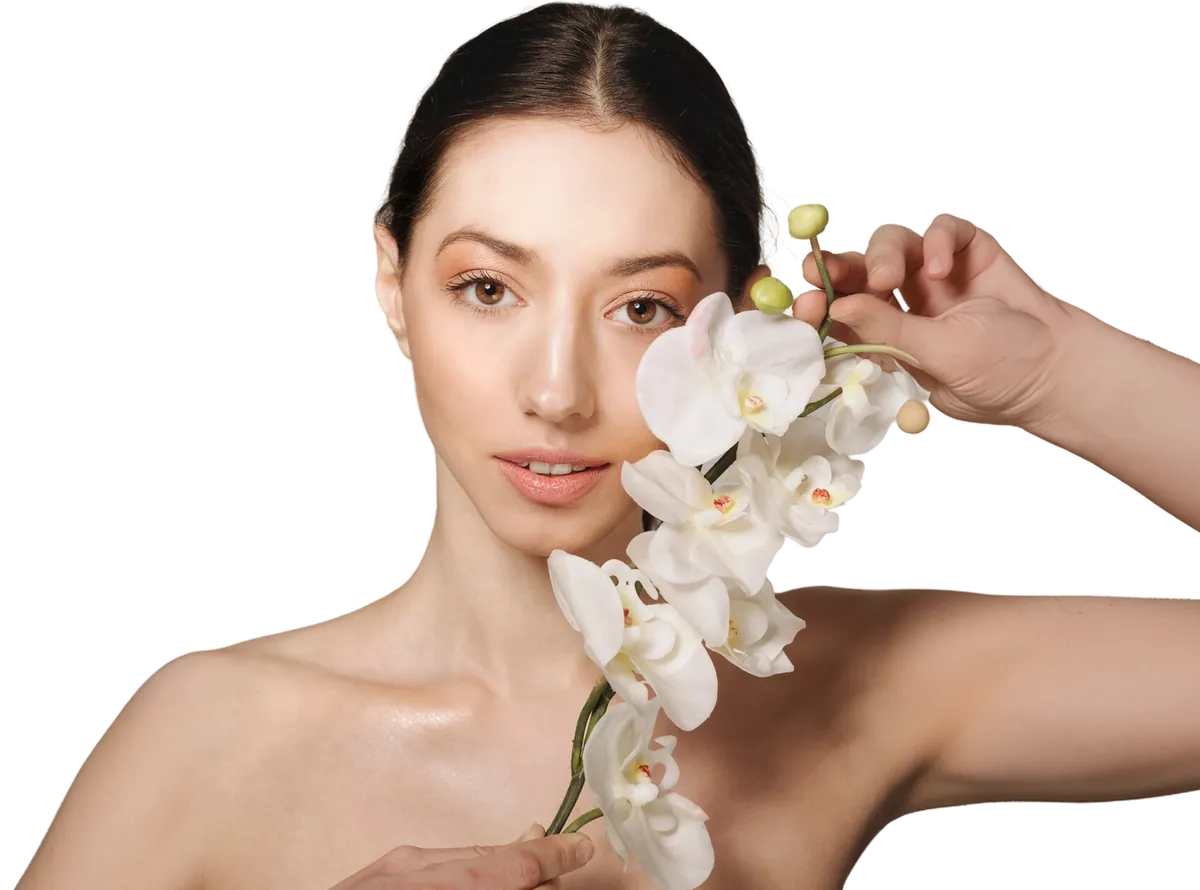 Woman holding white orchids beside her face