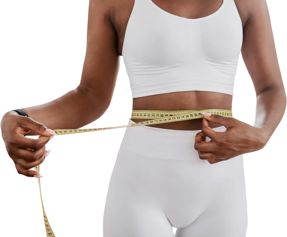 Slim woman in white measuring her waist with a tape measure