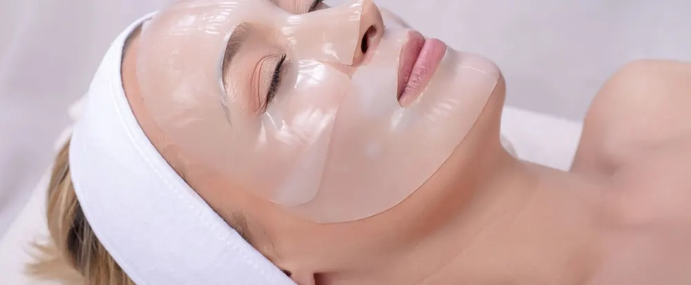 Woman with a CO2 carboxy gel mask applied during a facial