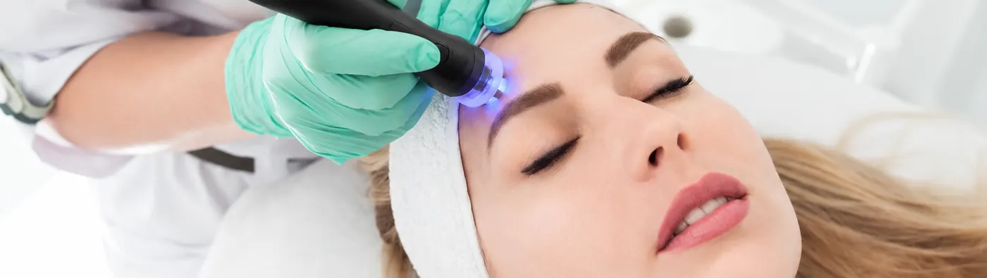 CoolJet cold plasma device used on a client's forehead