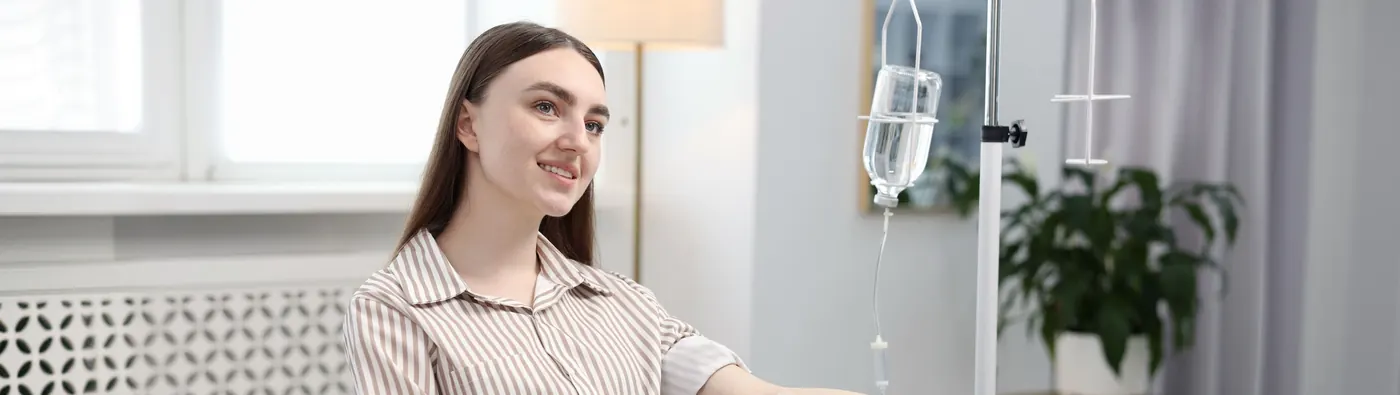 Client receiving an IV infusion in a private treatment room
