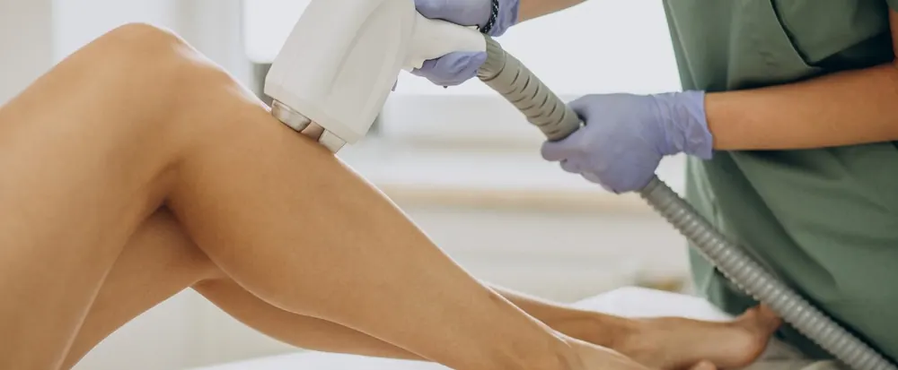 Laser hair removal device on a client's leg