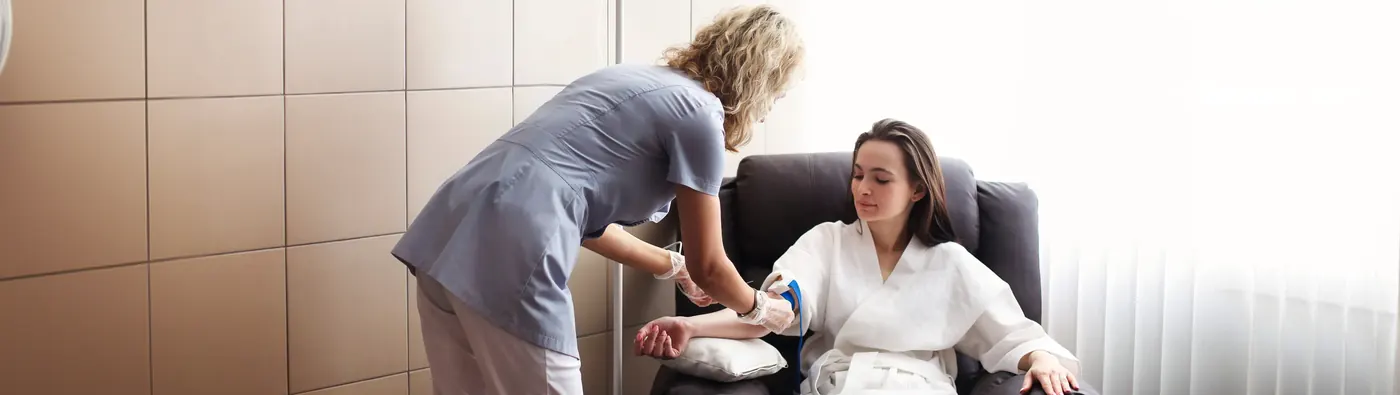 Nurse preparing an NAD+ infusion for a client