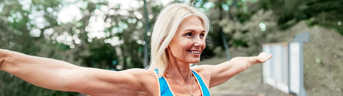 Active woman stretching her arms outdoors