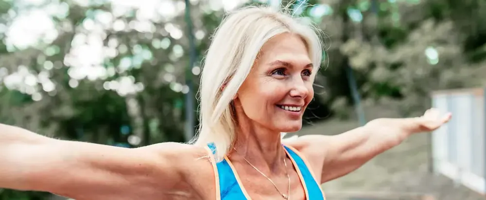 Active woman stretching her arms outdoors