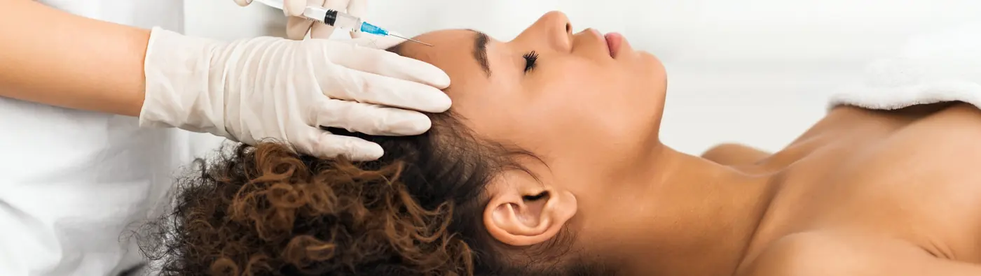 Provider giving a PRP scalp treatment